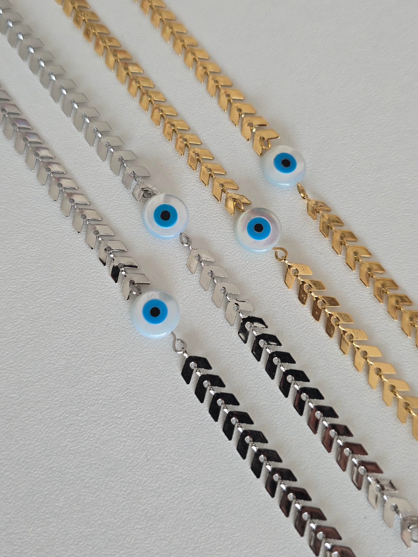 Bracelet en acier inoxydable argenté et doré avec oeil bleu protecteur