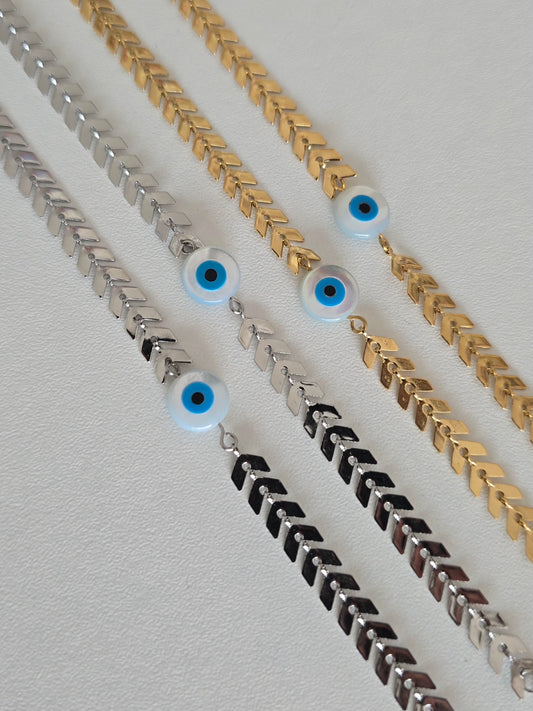 Bracelet en acier inoxydable argenté et doré avec oeil bleu protecteur
