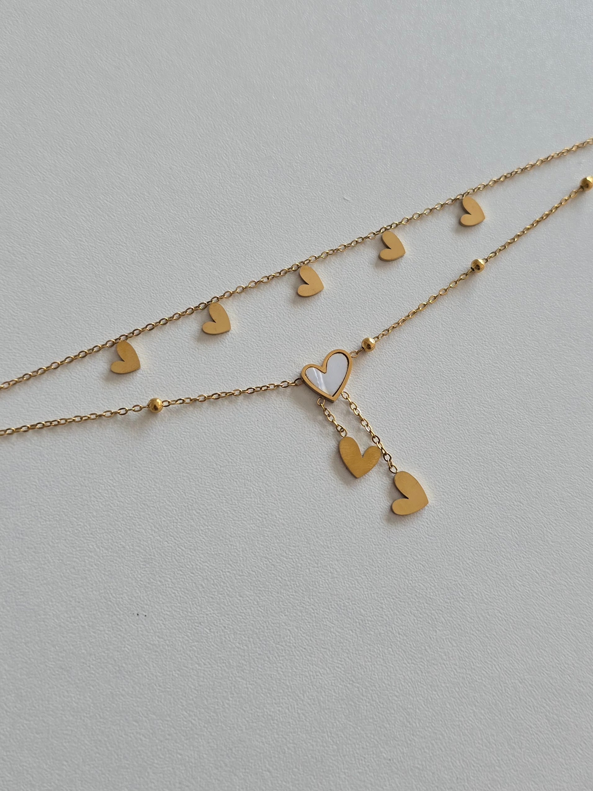 bracelet de cheville Lova en acier inoxydable doré avec double chaîne et coeur blanc irisé