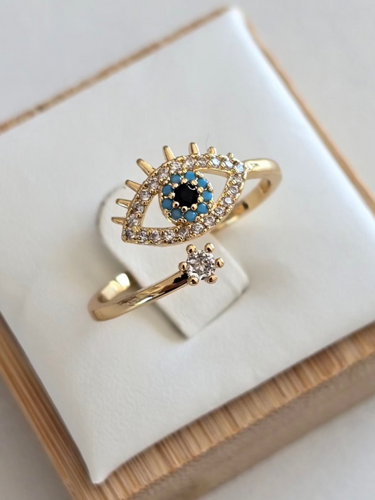 Bague Oryna dorée avec oeil protecteur serti de strass argentés, bleus et noirs
